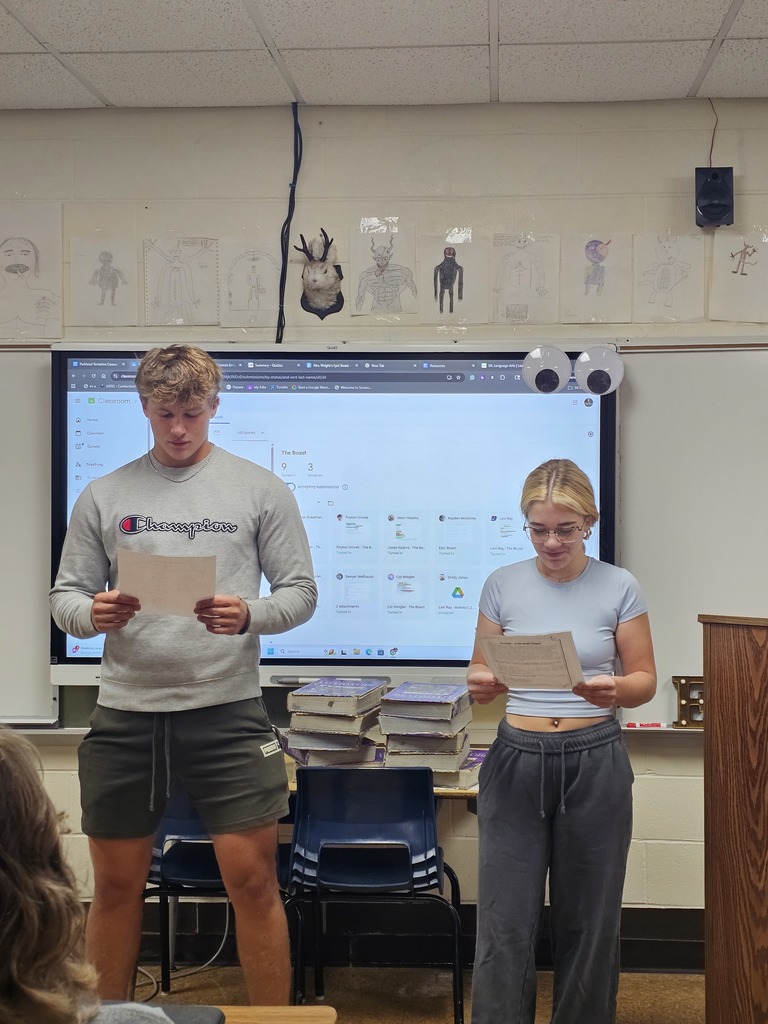 Two students are presenting to the class. 
