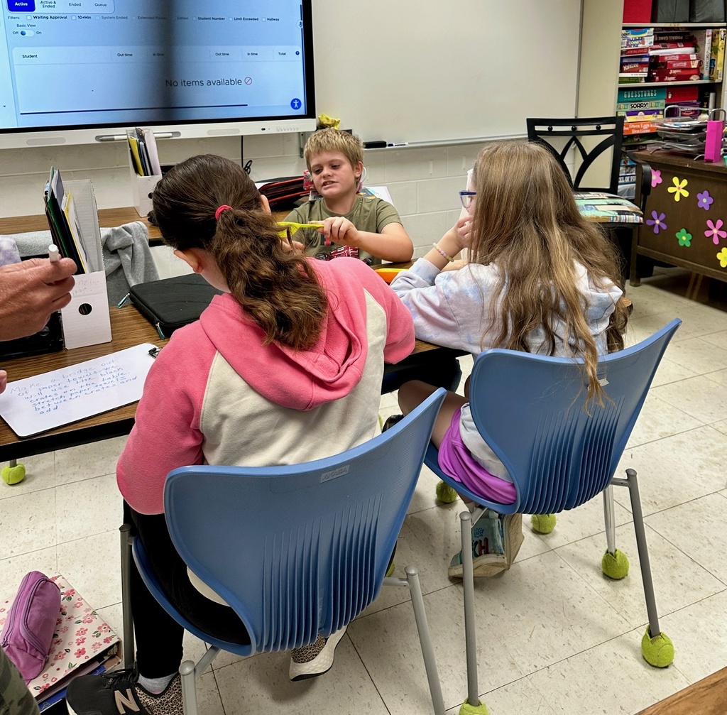 The students are preparing an experiment to find the best paper towel. 