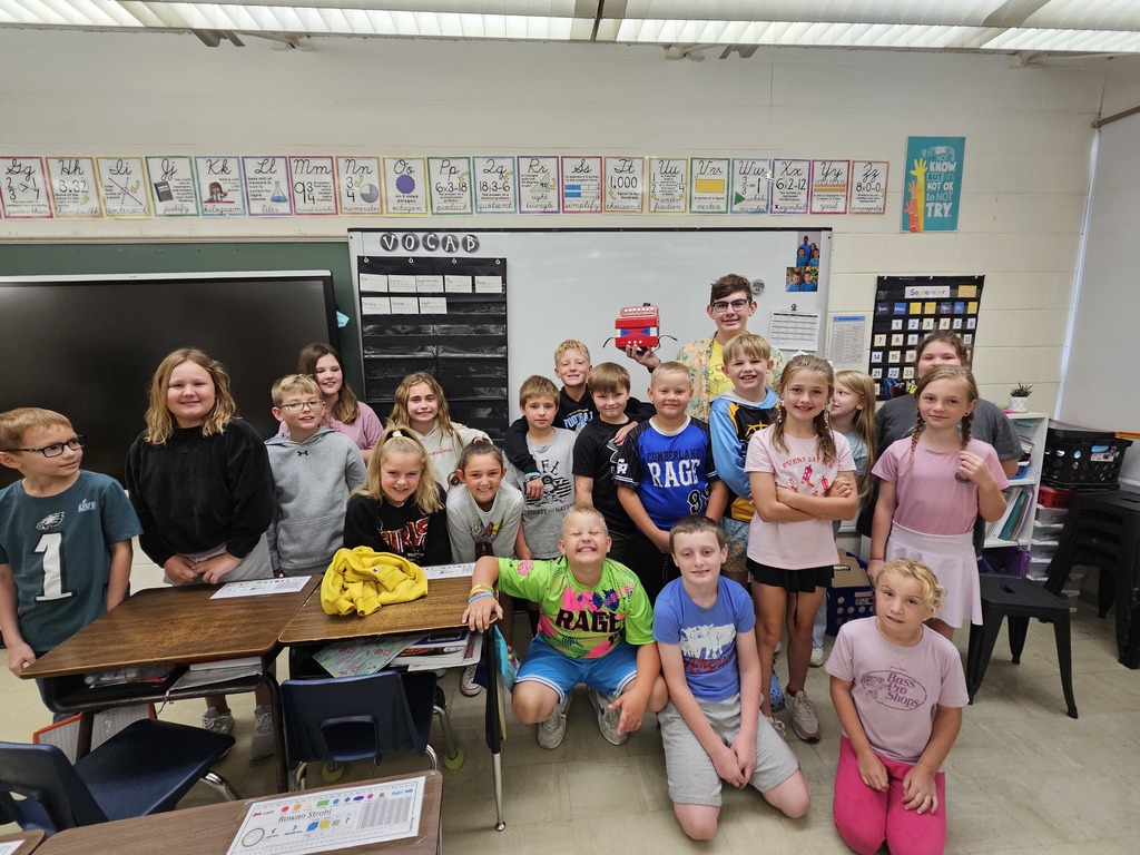 The class is posing with Brooks.