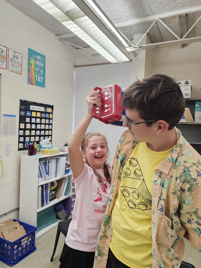 A student is playing the accordian in Brooks's ear.