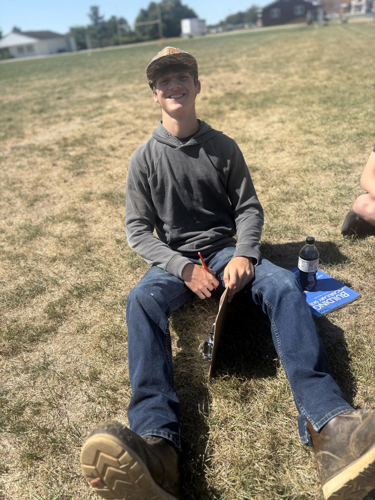 Student is working on vocabulary in the grass.