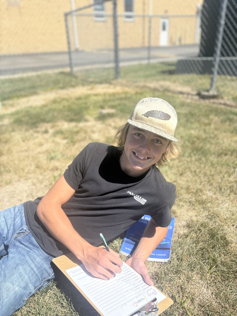 Student is working on vocabulary in the grass.