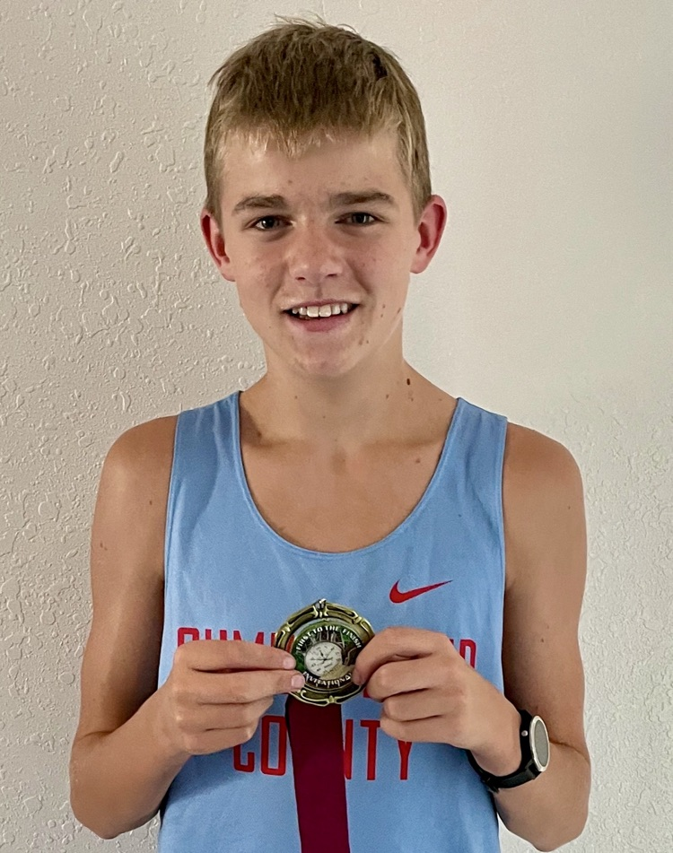 Colby is pictured holding his medal  