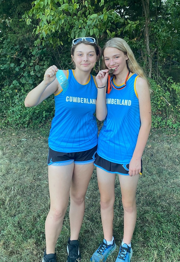 JV runners displaying their medal and ribbon. 