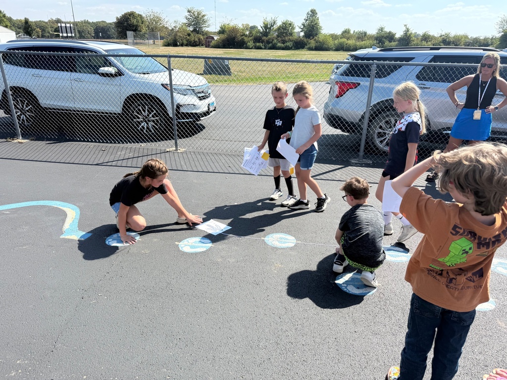 Students are measuring to see if they are faster than a dinosaur. 