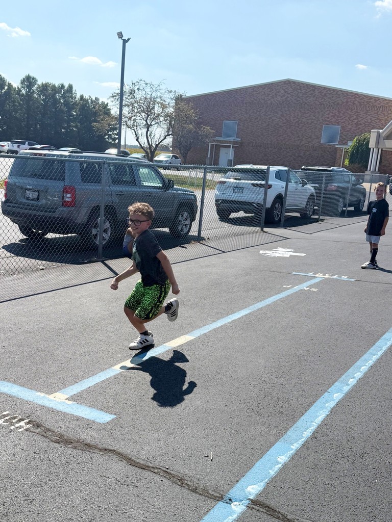 A student is trying to be faster than a dinosaur. 