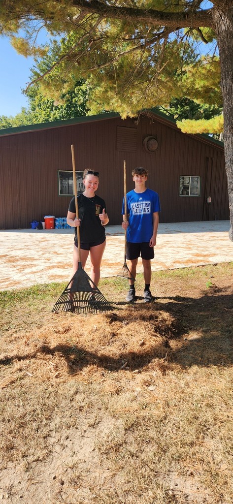 Two students are raking.