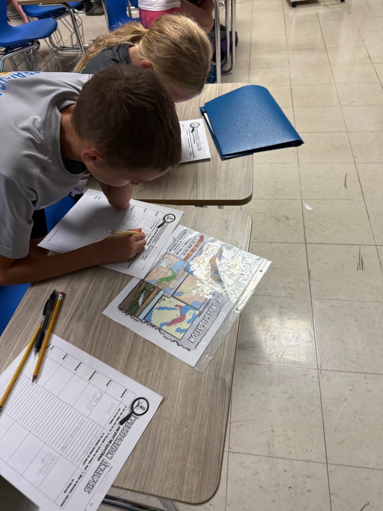 Students are at a station investigating ancient Mesopotamia.