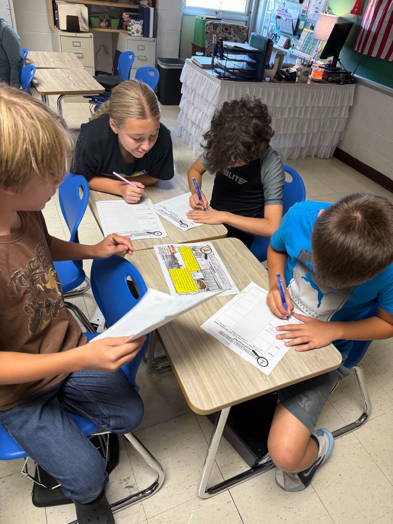 Students are at a station investigating ancient Mesopotamia.