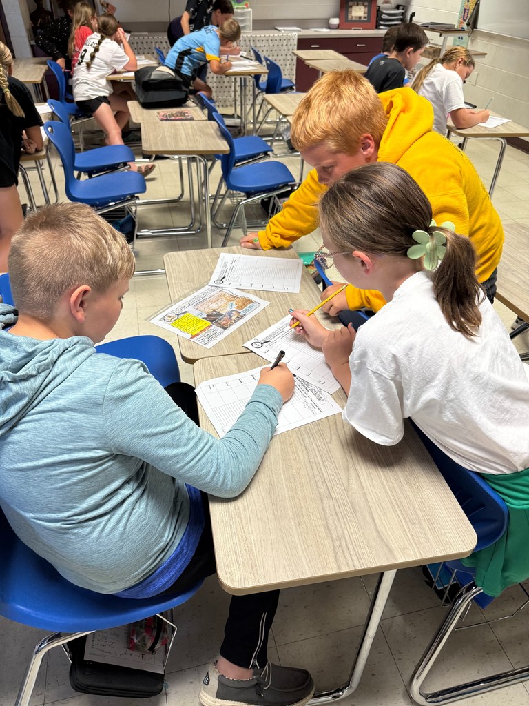 Students are at a station investigating ancient Mesopotamia.