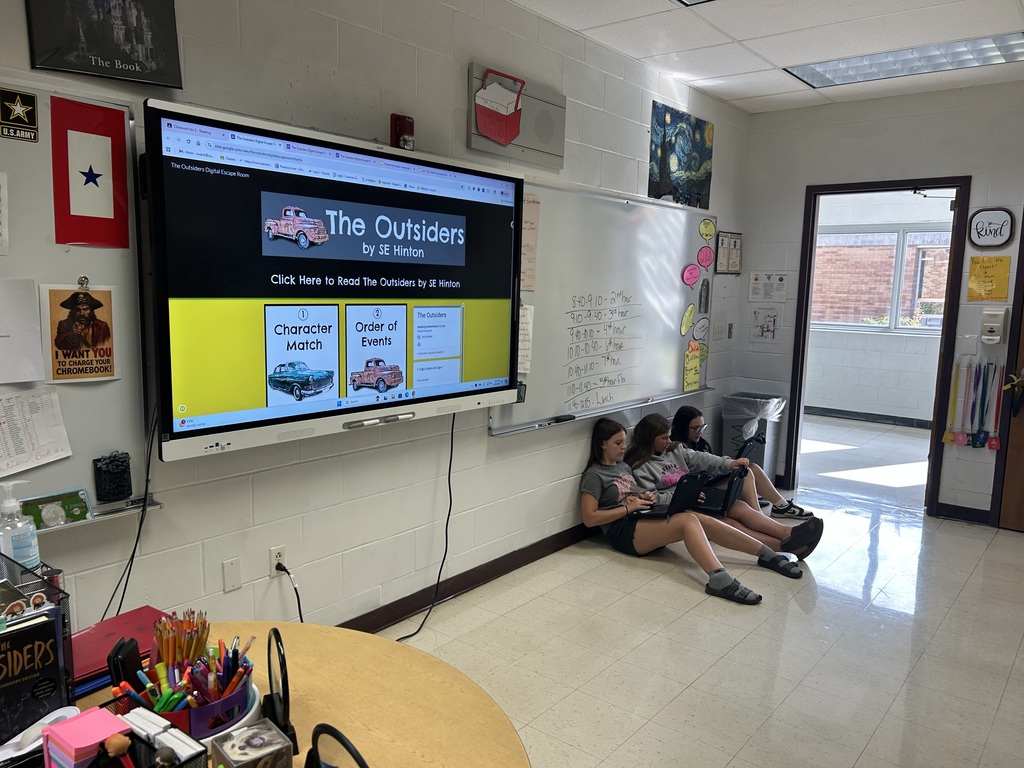 Students are collaborating on an Outsiders Escape Room.
