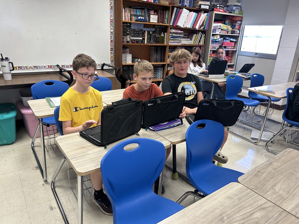 Students are collaborating on an Outsiders Escape Room.