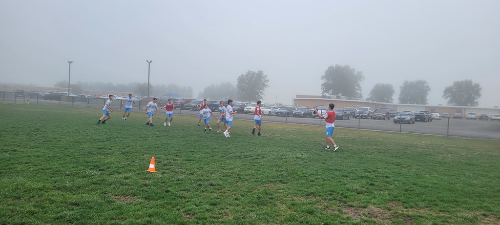 Students are playing flag football on the foggy morning of PE.