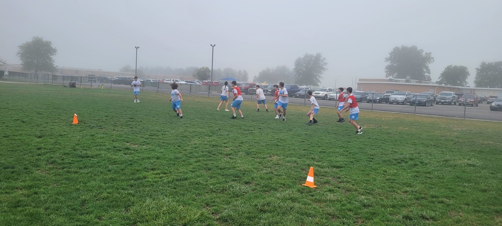 Students are playing flag football on the foggy morning of PE.