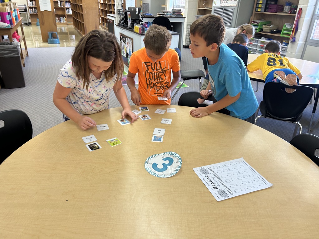 Students are matching call numbers to books. 
