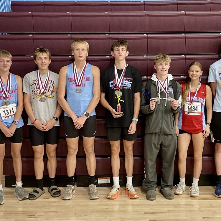 The boys and girls medalists are standing with their medals