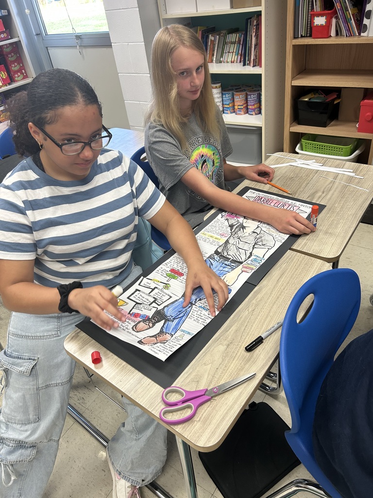 Two students are putting together their project.