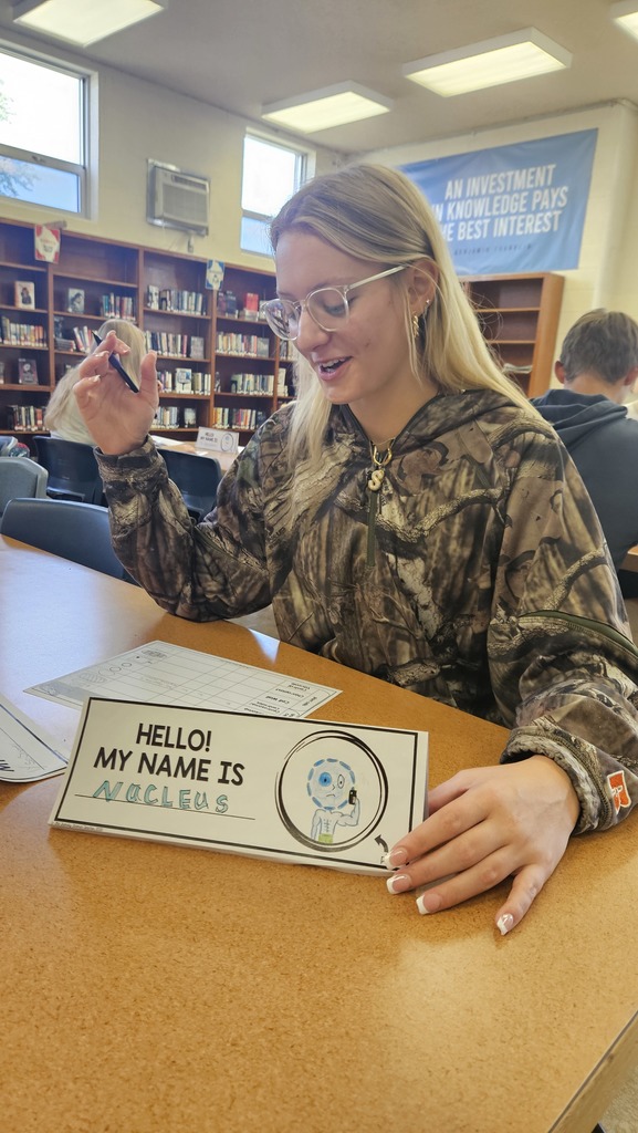 A student is acting as the nucleus during Organelle speed dating.