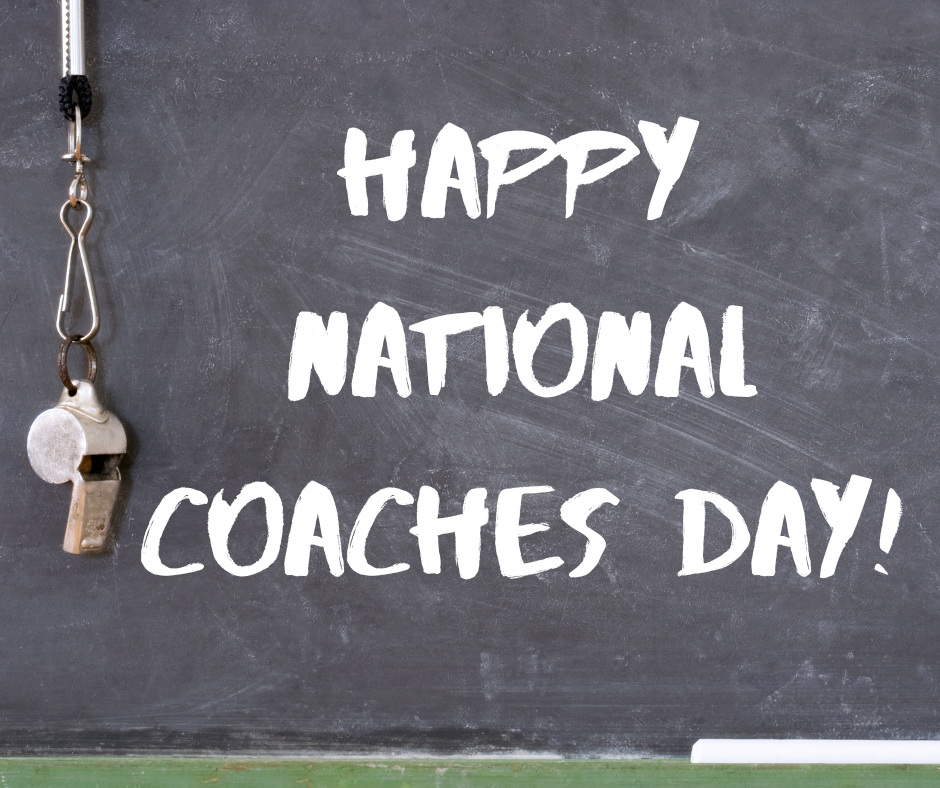 There is a message on a chalkboard that says happy national coaches day! There is a whistle hanging on the chalkboard.