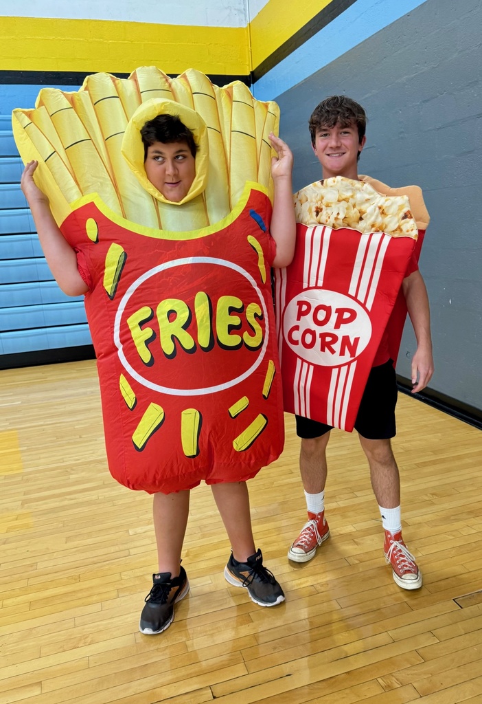 One student is dressed as an inflatable container of french fries. The other is wearing a box of popcorn.