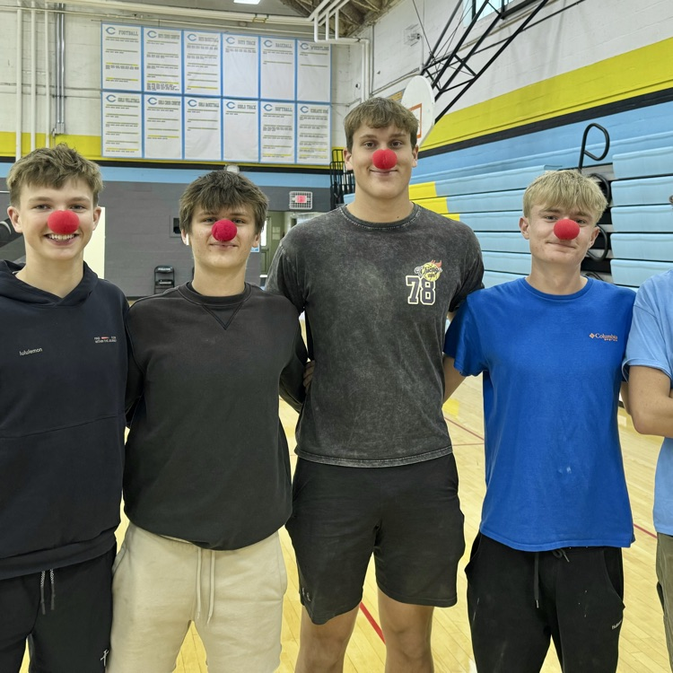 five students are standing side-by-side. They are all wearing clown noses.
