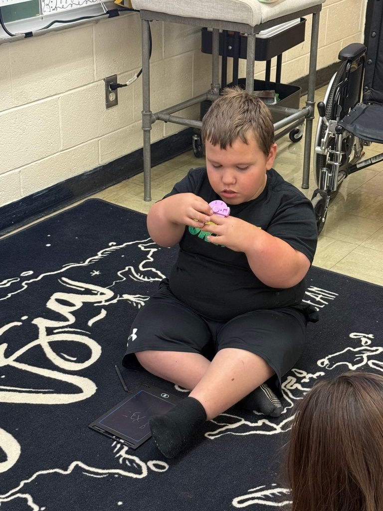 A student is using multiplication math fidgets and math "keys" to practice their math facts.
