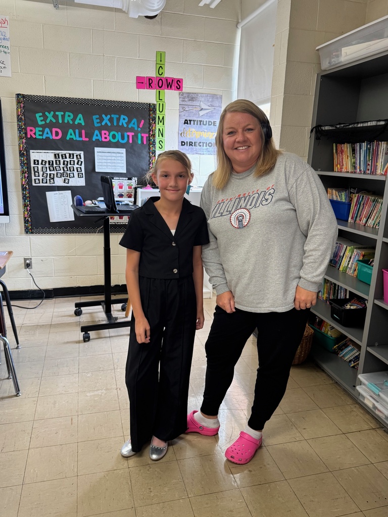 The student is dressed in a dresssuit. The teacher has sweats, crocks and socks.