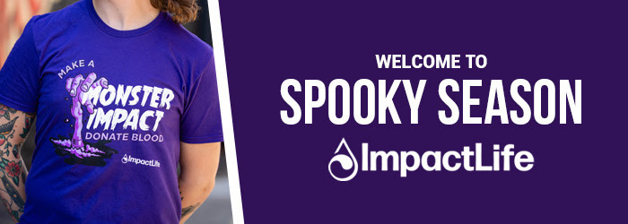 The image is of someone wearing a purple t-shirt. The shirt says Make a Monster Impact Donate Blood. ImpactLife.