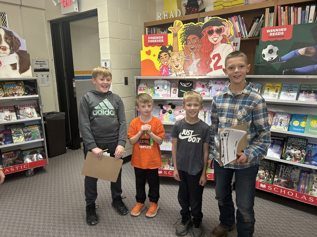 Older students are writing down lists on clipboards. Younger students are making their choices.