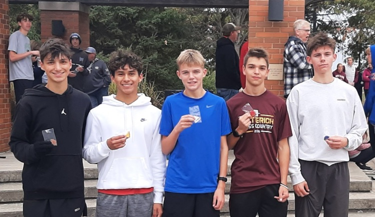 Pictured are the top five boys runners. Each is holding his medal