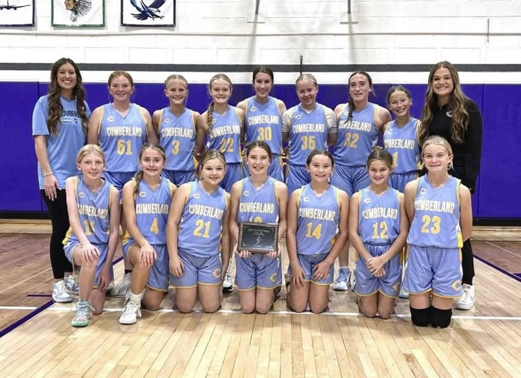 This is a team picture with the girls in front holding the plaque.