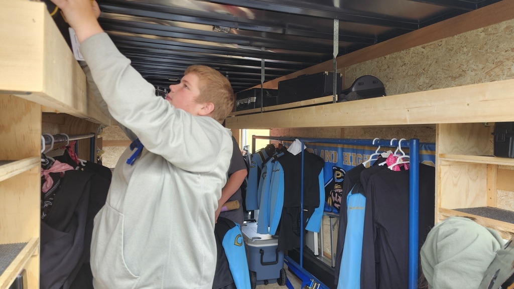 Members of the band are unloading their trailer after the last band completition.
