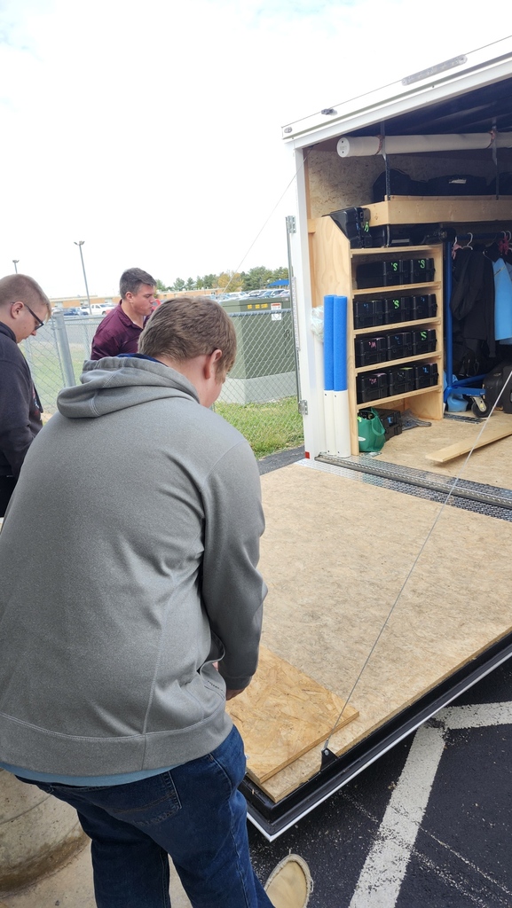 Members of the band are unloading their trailer after the last band completition.
