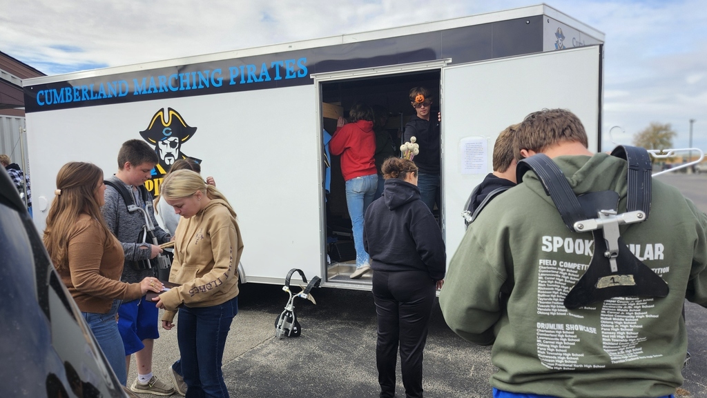 Members of the band are unloading their trailer after the last band completition.