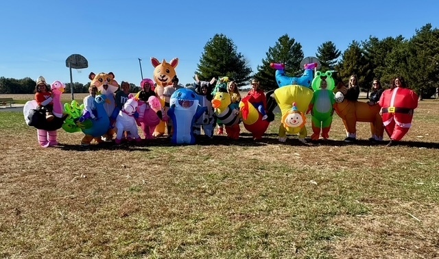 All of the staff are posing in their inflatable costumes.