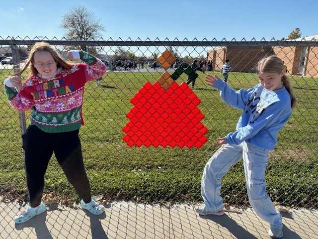 The students are kneeling by their design. It is a