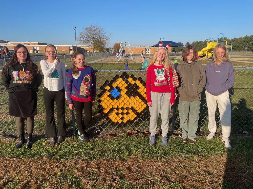 The students are standing by their design. It is a pirate head.
