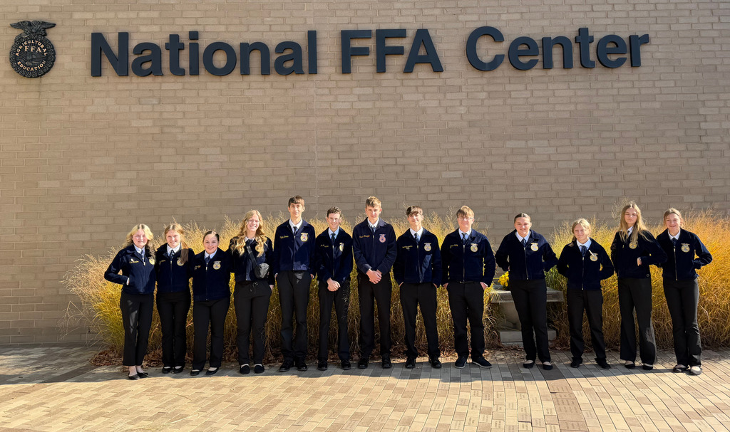The group is standing in front of the National FFA Center.