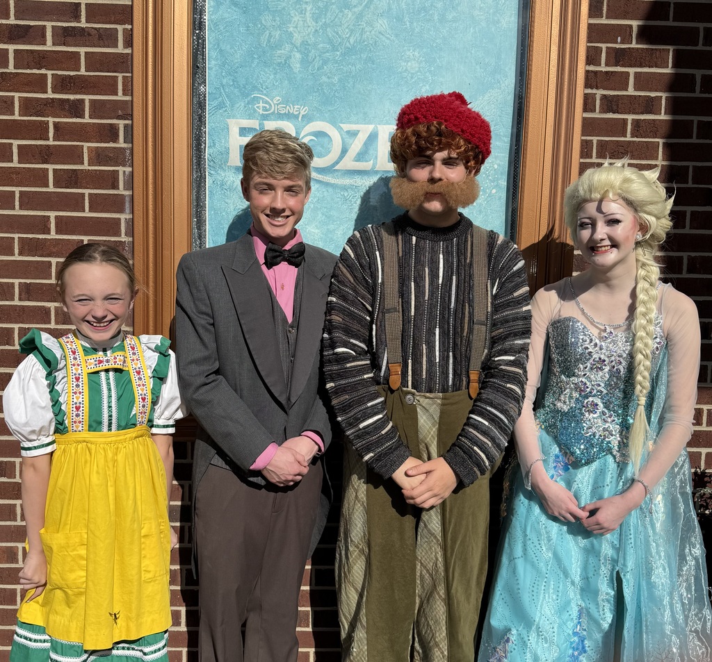 Pictured are the four students who were in the show. They are in costume. 