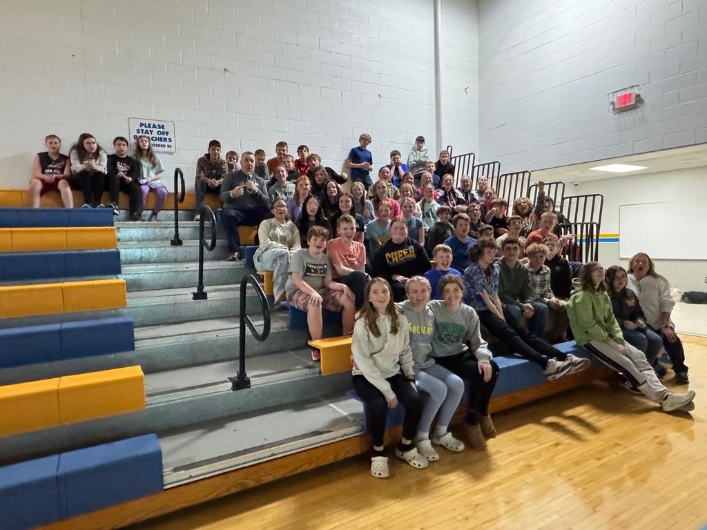 Kevin is sitting with the group of students. 