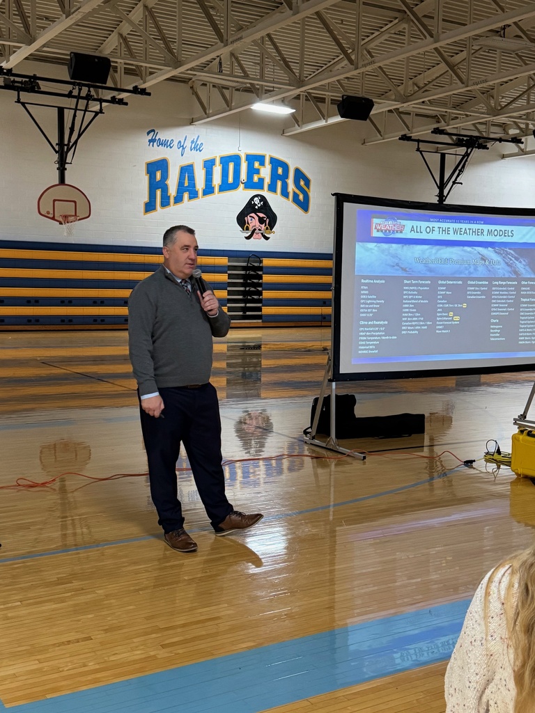 Mr. Lighty is speaking to the group in the gym. 