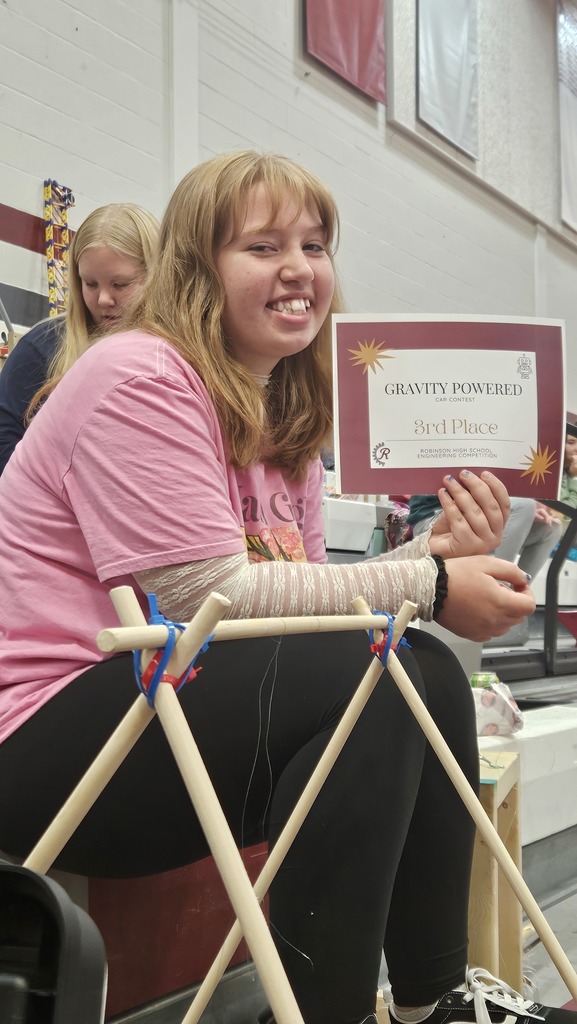 A student is showing one of her certificates. 