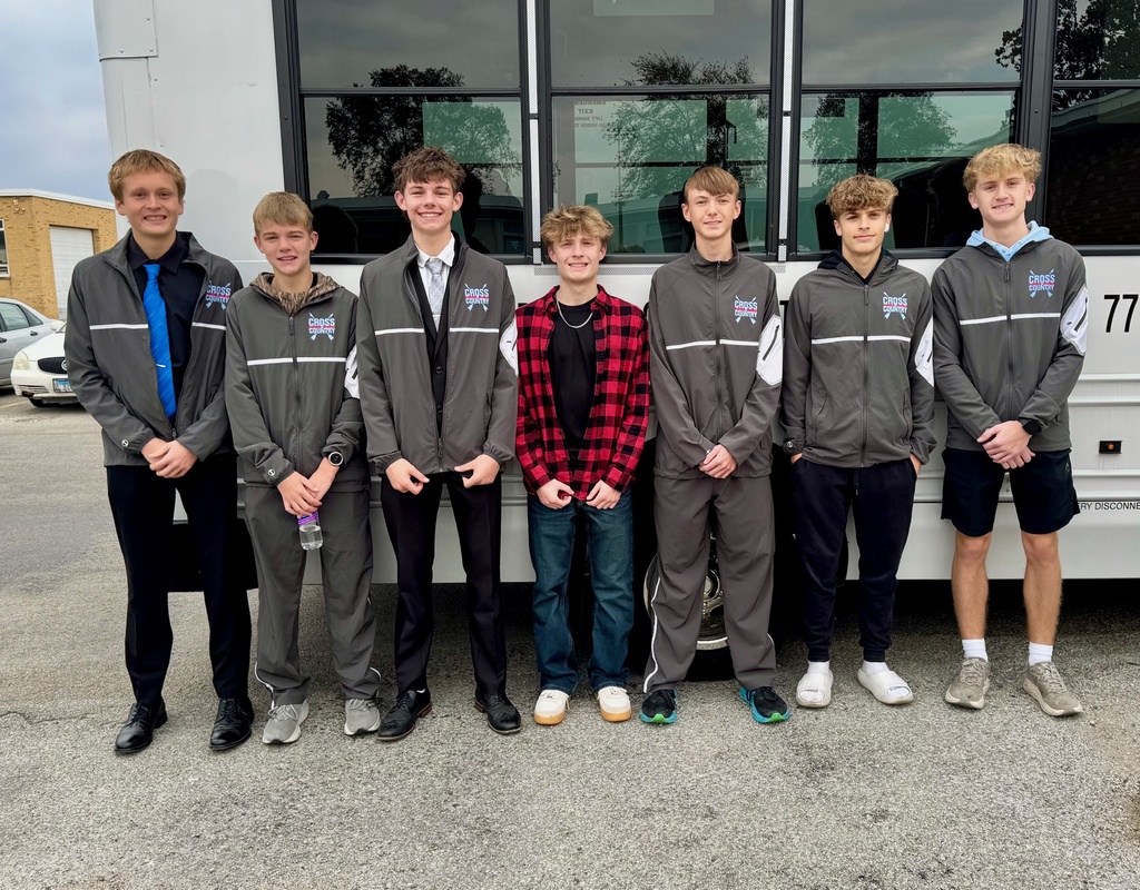 Pictured are the members of the cross country team in front of their bus. 