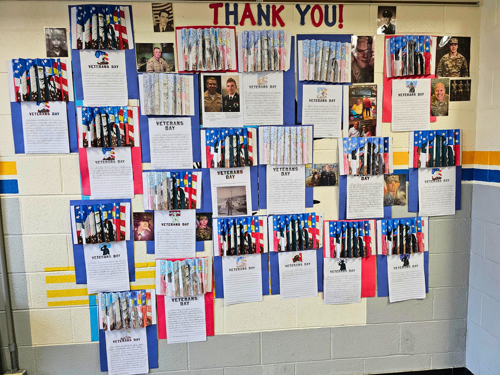 Pictured are the projects the students made. They are decorated in red, white, and blue images and pictures. The students wrote a paragraph reflection about veterans.