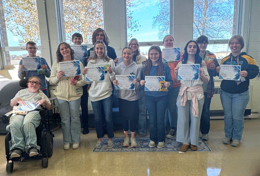 13 students are pictured with their certificates and treat from the NHS.