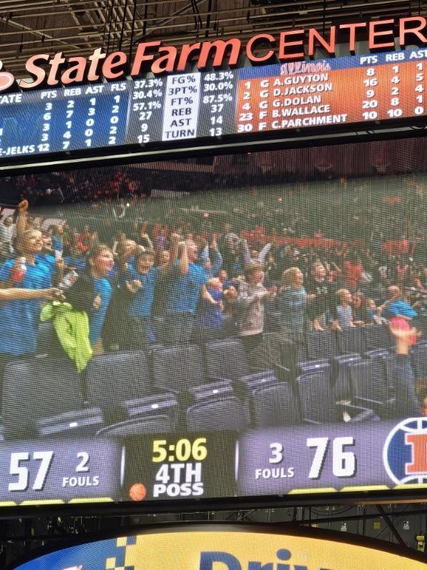 Students in are cheering because they noticed they are on the jumbo screen. 