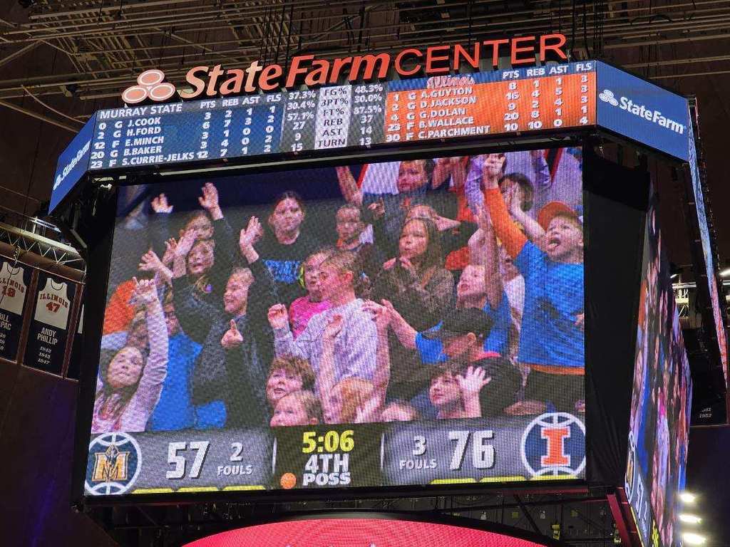 Students in are cheering because they noticed they are on the jumbo screen. 