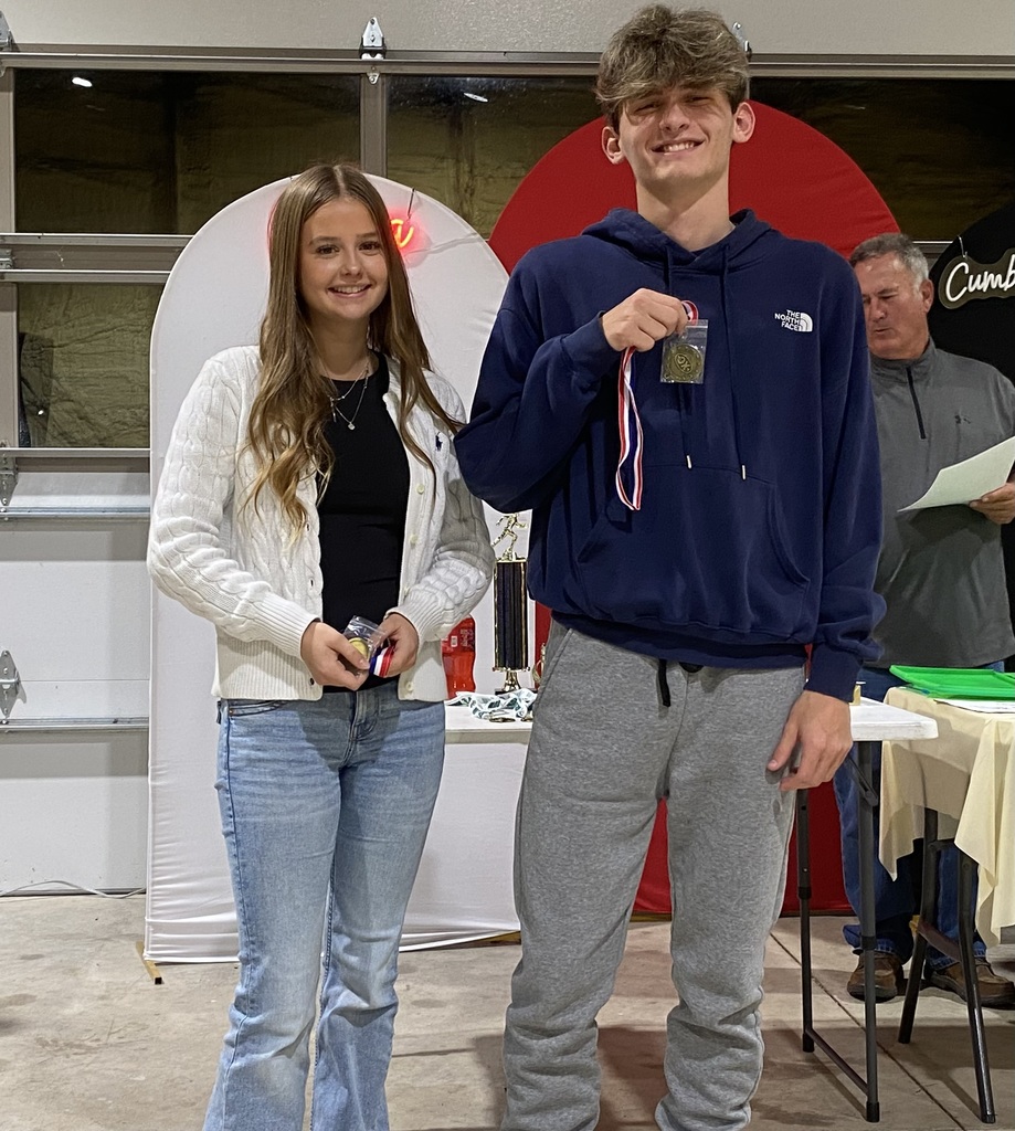 The two individuals who won the Most Improved awards are holding their plaques.
