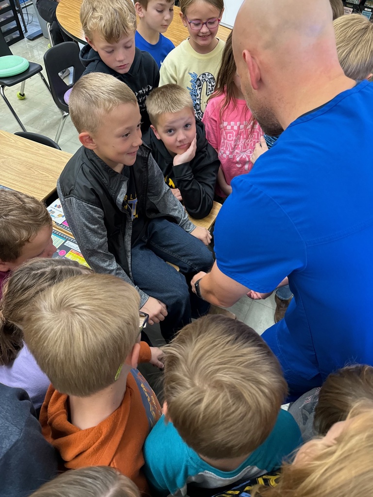 The speaker is showing how reflexes in the knee work.