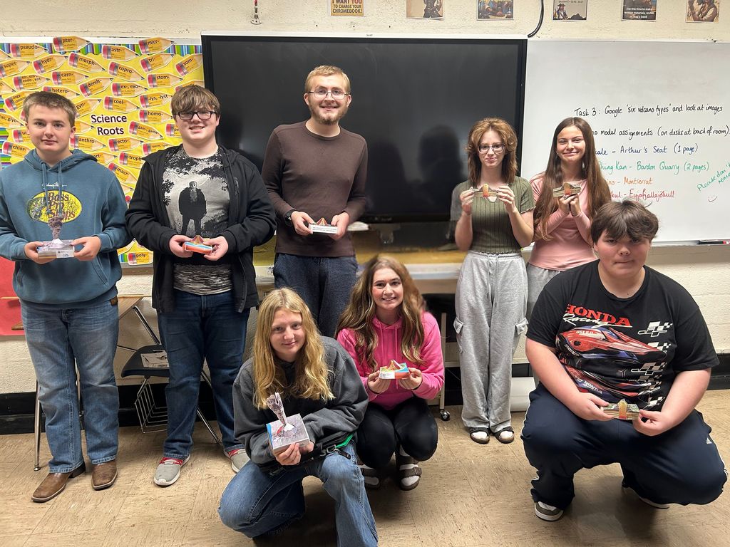 This is a group picture. Each student is holding their volcano. 